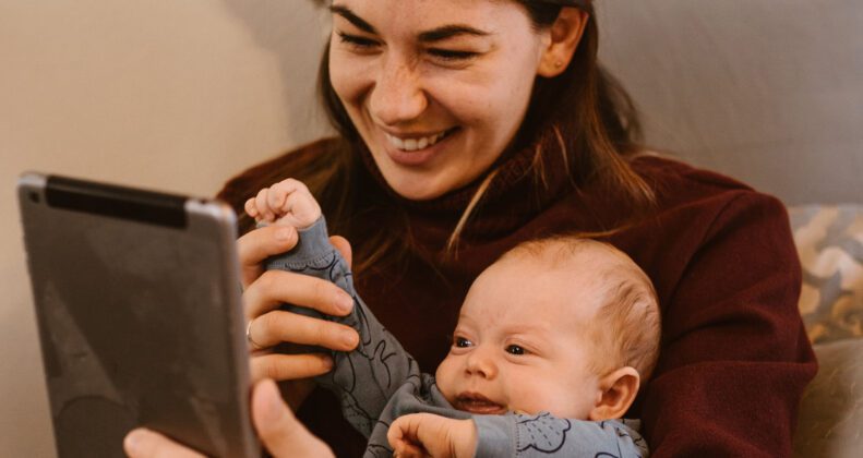 baby and mom watching baby sensory video on tablet